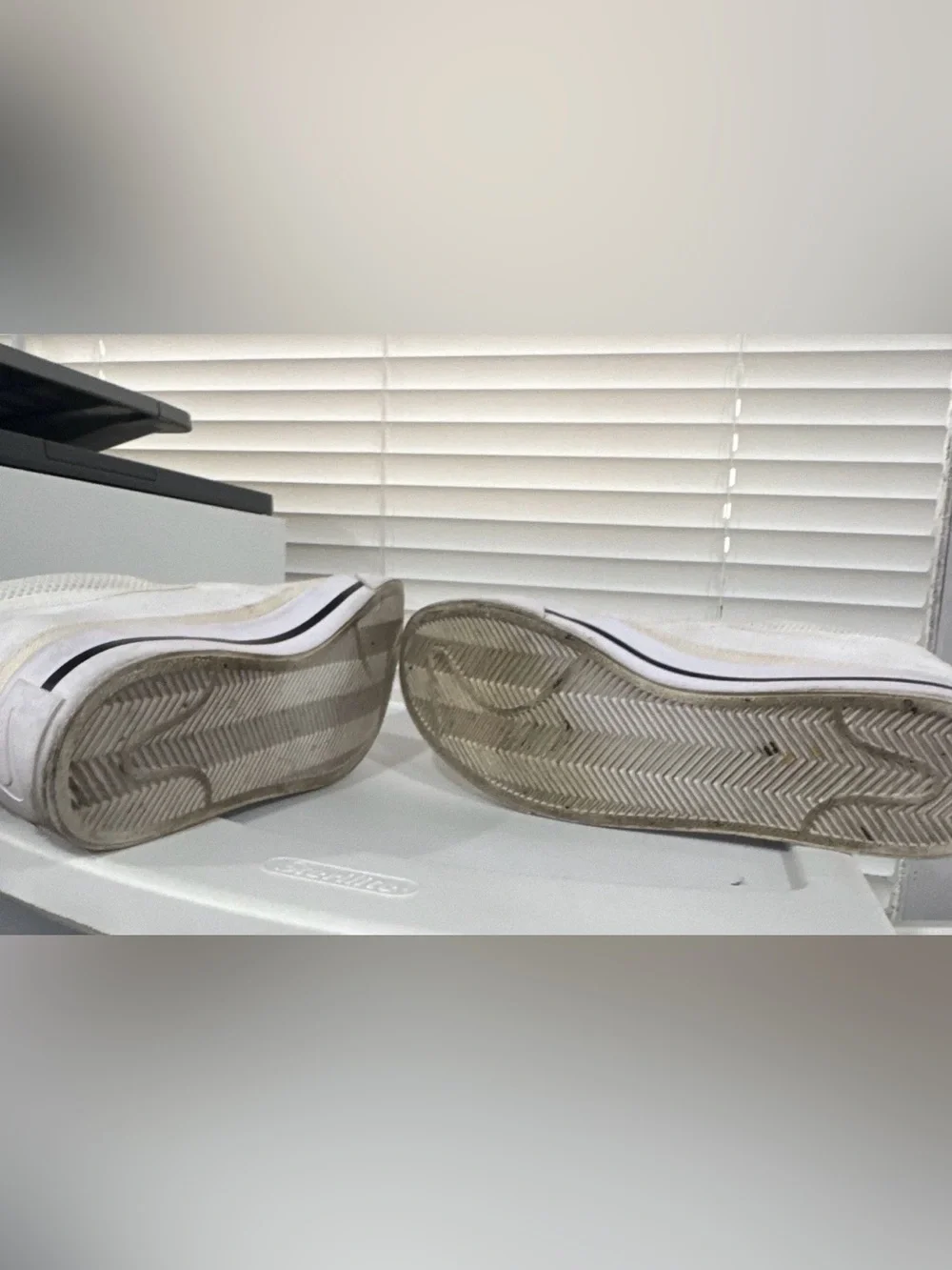 Nike Women’s White Slip-On Sneakers with Black Swoosh Accent
